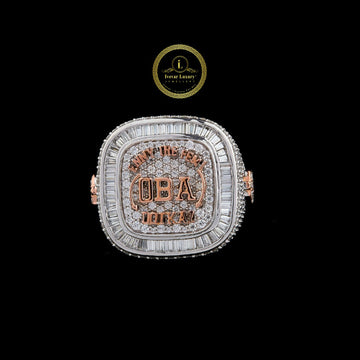 Custom two-tone moissanite championship ring with rose gold lettering and a baguette-cut moissanite halo