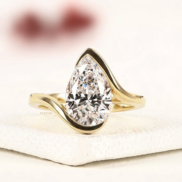 Pear Cut Moissanite Diamond Bypass Ring in Half Bezel Setting